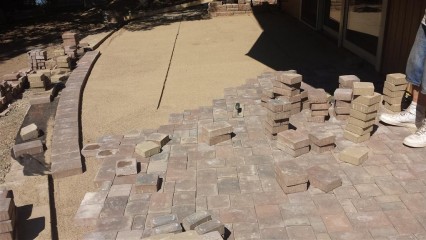Adding the brick pavers on a bed of sand
