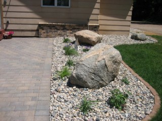 River rock and large boulders. Bullet pavers for edging.