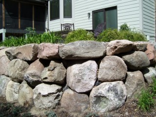 Boulder wall with mulch